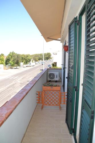 a balcony with a table and a tv on a building at B&B Gi & Giò in Càbras