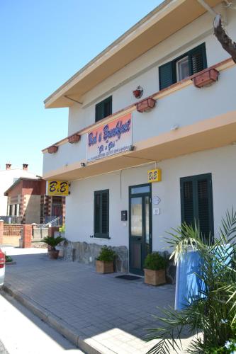 a building with a sign on the side of it at B&B Gi & Giò in Càbras