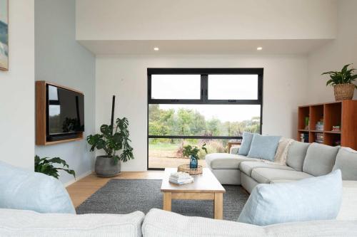a living room with a couch and a table at Ocean Vista Escape Jan Juc in Bellbrae