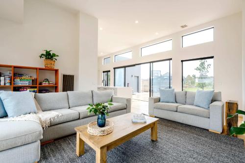 a living room with two couches and a coffee table at Ocean Vista Escape Jan Juc in Bellbrae