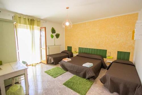 a living room with two beds and a couch at Le Cromie B&B in Catignano
