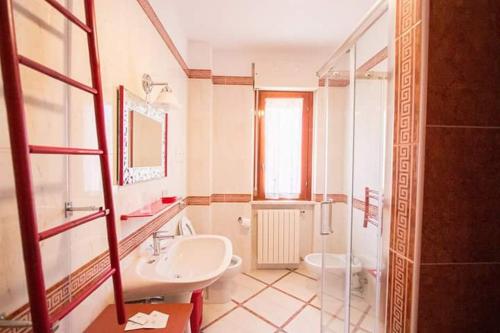 a bathroom with a sink and a toilet and a shower at Le Cromie B&B in Catignano