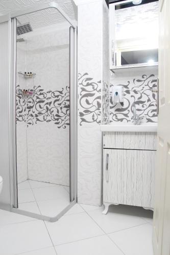 a shower with a glass door in a bathroom at Kural Pansiyon in Amasra