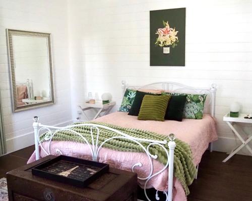 a bedroom with a white bed and a mirror at Smithtown Champagne Bed and Bubbles in Smithtown