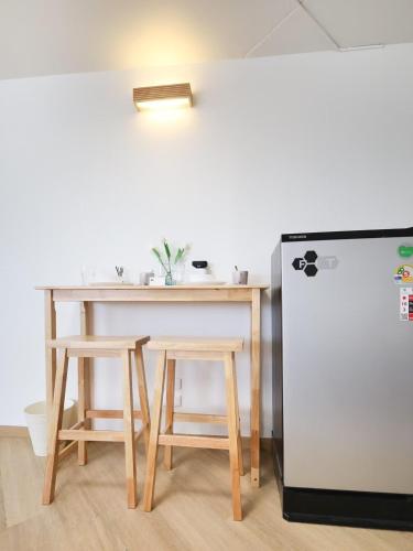 a table and two chairs and a refrigerator at 3 Beds,WiFi,Washing Machine,IMPACT Arena at T9 in Ban Bang Phang