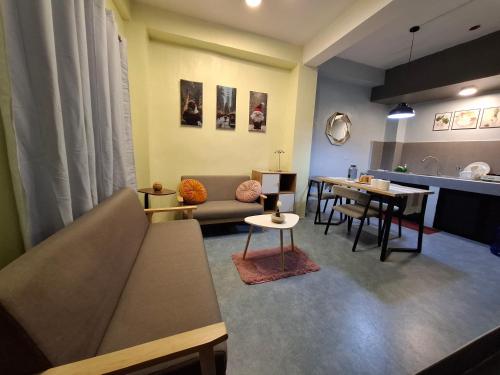 a living room with a couch and a table at The Baluarte in Maasin