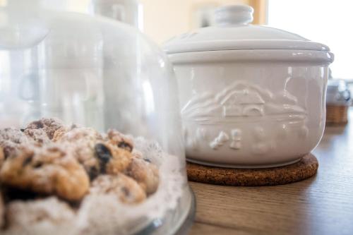 a glass container of donuts sitting on a table at Agriturismo Sanguineto in Acquaviva