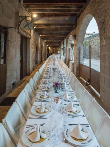 a long table with plates and wine glasses at Hotel Cal Sastre in Santa Pau
