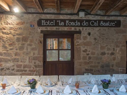 a table set up for a wedding in a stone building at Hotel Cal Sastre in Santa Pau