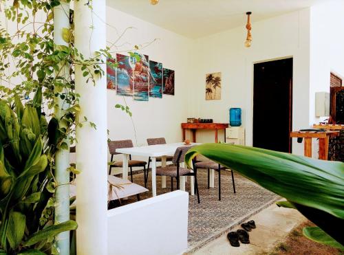 a room with a table and chairs and plants at White Tern Maldives in Fenfushi