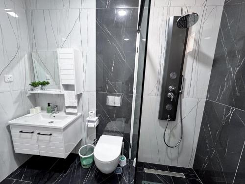 a bathroom with a shower and a toilet and a sink at Mombasa Nyali opp Baobab Resort in Mombasa