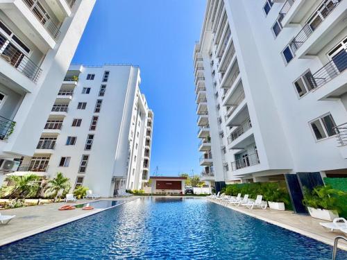 a swimming pool in the middle of two tall buildings at Mombasa Nyali opp Baobab Resort in Mombasa