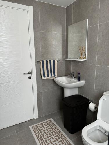 a bathroom with a sink and a toilet and a mirror at SunValley Cove Studio by HolidayKeys in Kyrenia