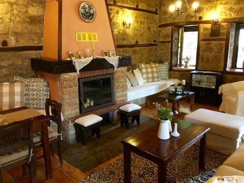 a living room with a couch and a fireplace at Varosi Guesthouse in Edessa