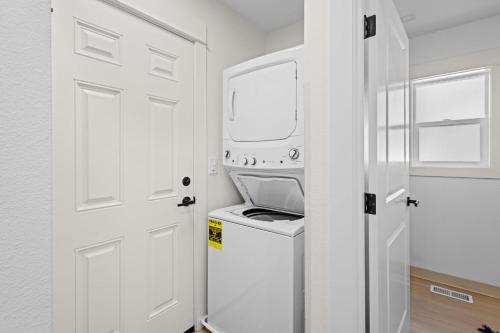 a white laundry room with a washer and dryer at Seaside Getaway B in Seaside