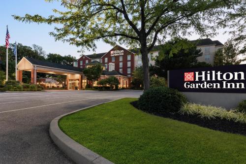 a hotel with a sign in front of a building at Hilton Garden Inn Harrisburg East in Harrisburg