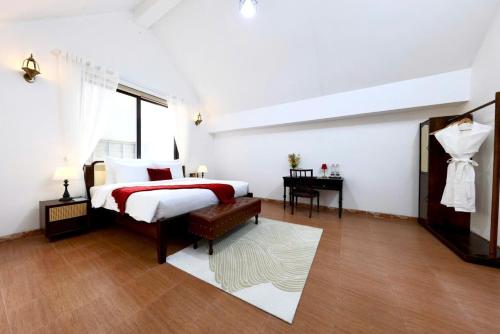 a white bedroom with a bed and a desk at 500m2 Private Villa 2 min to West Lake 7BR in Hanoi