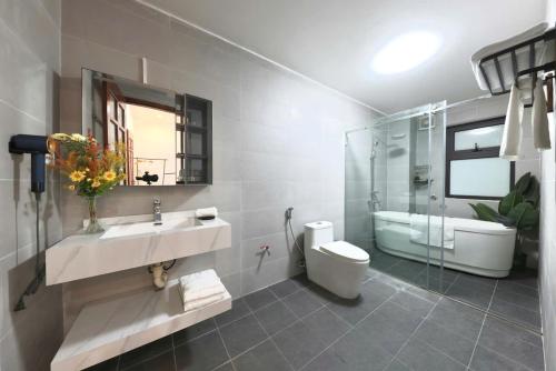 a bathroom with a sink and a toilet and a shower at 500m2 Private Villa 2 min to West Lake 7BR in Hanoi