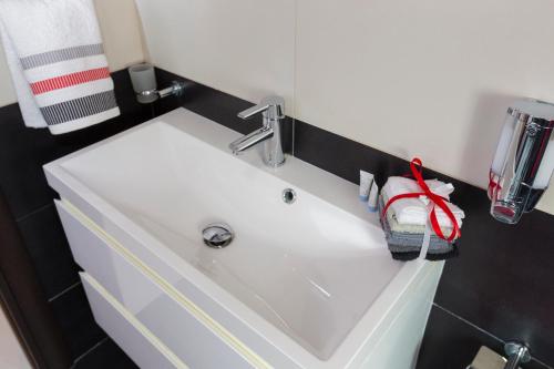 a bathroom sink with a red stuffed animal sitting on it at Marsascala 2 Bedroom Apartment close to Beach! in Marsaskala