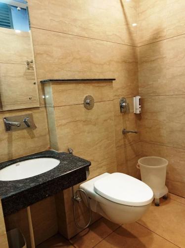 a bathroom with a toilet and a sink at MLS Prime Inn - Near Dehradun Railway Station in Dehradun