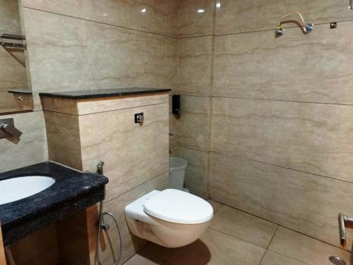 a bathroom with a toilet and a sink at MLS Prime Inn - Near Dehradun Railway Station in Dehradun