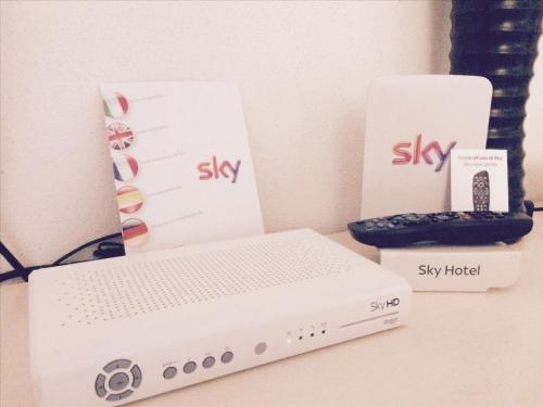 a desk with a box and a keyboard and a modem at Caveoso Hotel in Matera