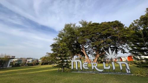 a sign that reads merril in a park at Merlin Hut & Farm in Kanchanaburi City