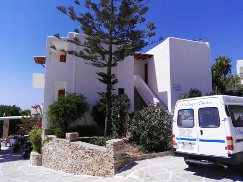 a white van parked in front of a building at Village Twins 1 in Ios Chora