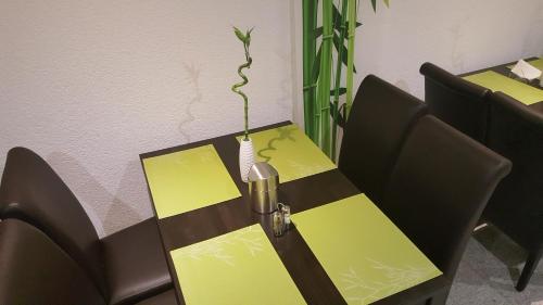 a table and chairs with a plant on top of it at Hotel Exquisite in Bobenheim am Berg