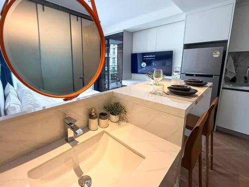 a bathroom with a sink and a mirror at Sunshine Layan Beach Resort studio #84191 in Layan Beach