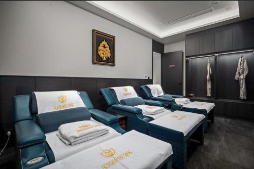 a room with four beds and chairs in it at Sunshine Layan Beach Resort studio #84191 in Layan Beach