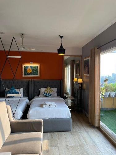 a bedroom with a bed and a couch at VIA VARANASI - A Boutique Hotel at Assi Ghat in Varanasi