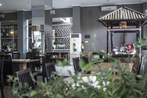 a restaurant with tables and chairs and a gazebo at Asoka Luxury Hotel in Tanjungkarang