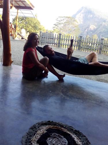 a couple of people sitting in a hammock at Ella Rawana Den Hotel in Ella