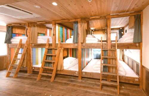 a group of bunk beds in a room at The Pax Hostel in Osaka