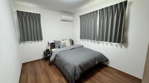 Postel nebo postele na pokoji v ubytování 81886大津町国際交流会館2f宿泊