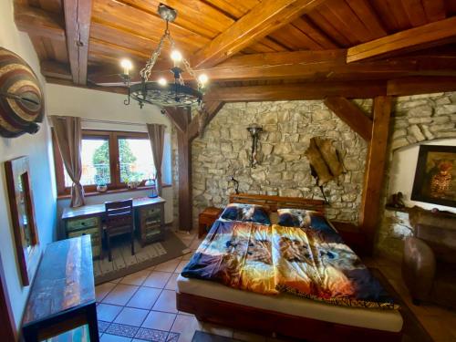 洛乌尼纳赫拉德巴赫酒店的一间带床和石墙的卧室