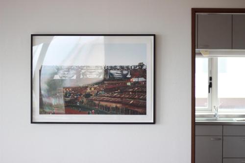 a picture hanging on a wall in a kitchen at Seaside Inn Hokuto in Hokuto