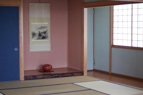a room with a vase sitting on the floor at Seaside Inn Hokuto in Hokuto
