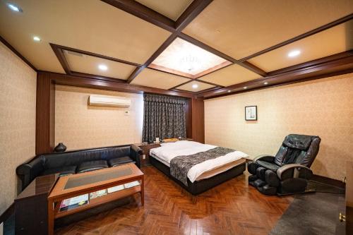 Ένα ή περισσότερα κρεβάτια σε δωμάτιο στο ホテルパティオ