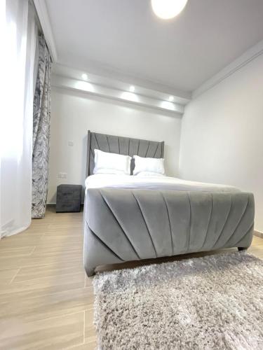 a bedroom with a large bed with a rug at 2 bedrooms apartment in Riverside drive in Nairobi