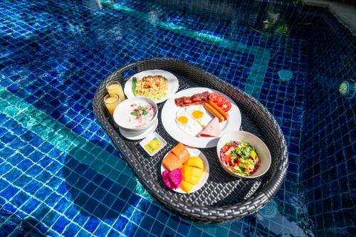 a tray of food on a table in a swimming pool at Pattaya Private 4-Bedrooms, 5-Bathrooms Pool Villa in Jomtien Beach