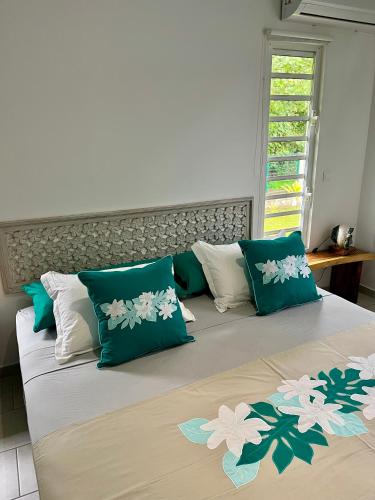 a bedroom with two beds with green and white pillows at Fare Araea in HUH
