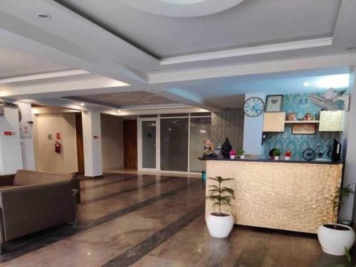 a lobby of an office building with a bar at Hotel O Rajiv Gandhi Bus Stop Bangalore Formerly Maharaja in Jālahalli