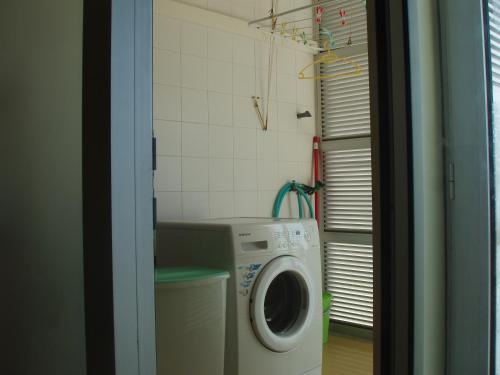 a washer and dryer in a small bathroom at Apartment T3 in Downtown with Sea View in Ponta Delgada