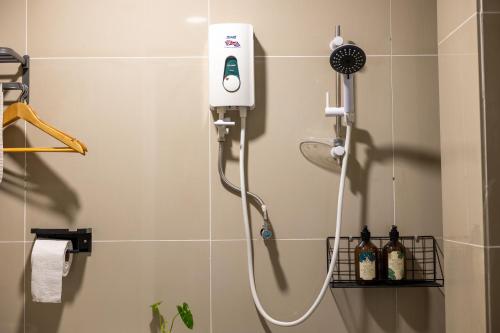 a shower in a bathroom with a blow dryer at Kenny Hill Boutique Hotel near Borneo Medical Centre Kuching in Kuching