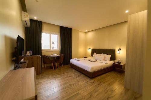 a hotel room with a bed and a table at Sofia Pyramids Hotel in Cairo