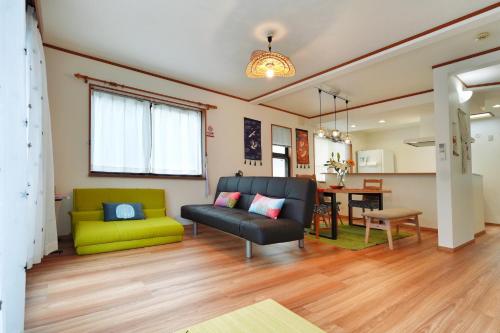 a living room with a couch and a table at Tokyo Tsuruga Villaー東京雅鶴 in Tokyo