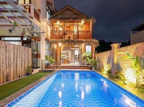 a swimming pool in the backyard of a house at Family Tan Thanh in Tân Thành (1)