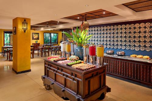 a restaurant with a buffet with plates on the wall at La Siesta Hoi An Resort & Spa in Hoi An